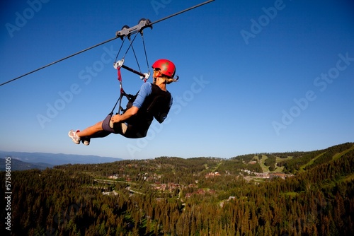A woman on a zip line tour in Whitefish, Montana. photo