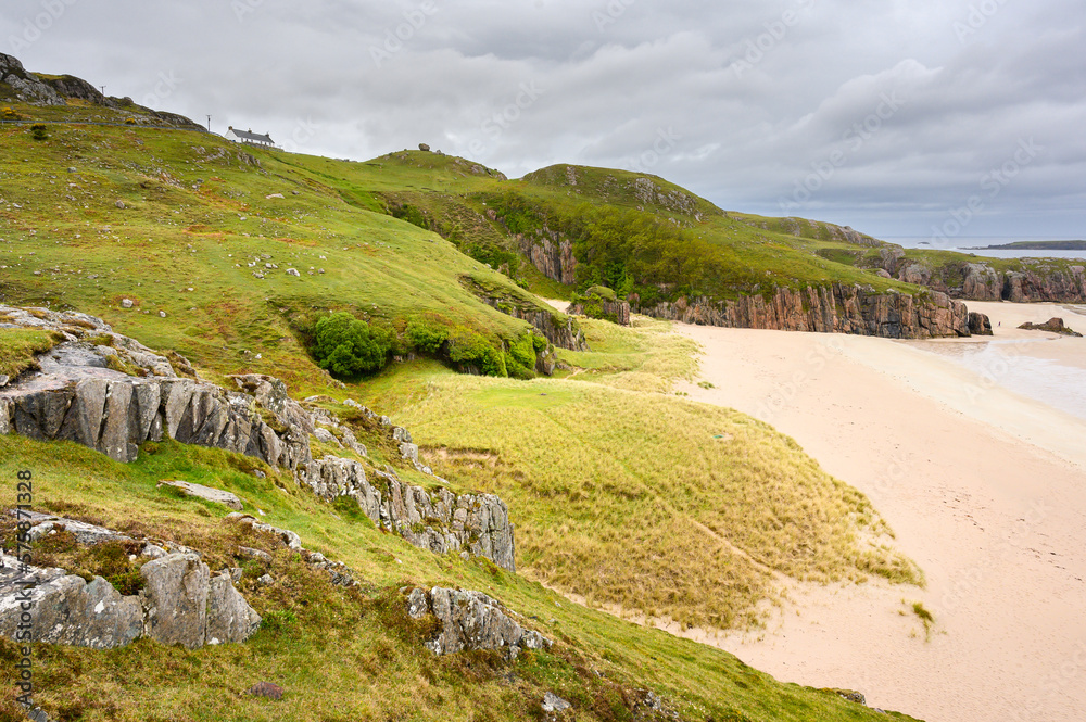 Stunning cliffs and white sand beach in the north of Scotland, United Kingdom