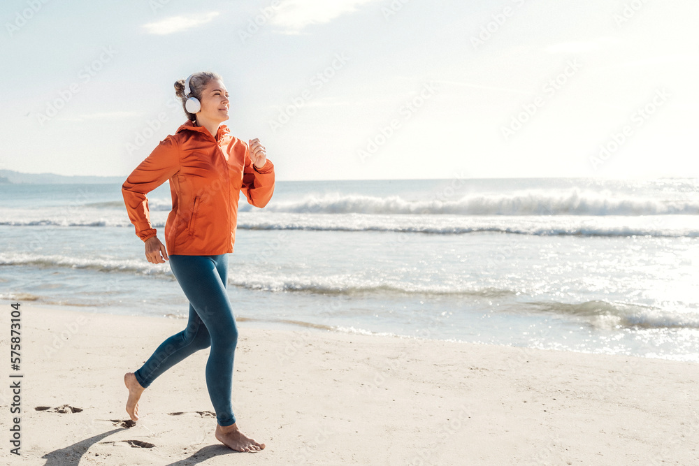 Woman jogging on shore at beach Woman jogging on shore at beach