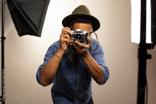 Man clicking photo using camera in studio
