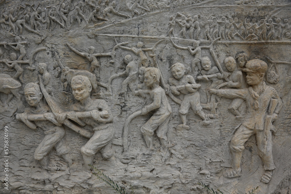 Memorial shrine festooned with bas-reliefs of Khmer Rouge atrocities at Wat Somrong Knong. Cambodia.