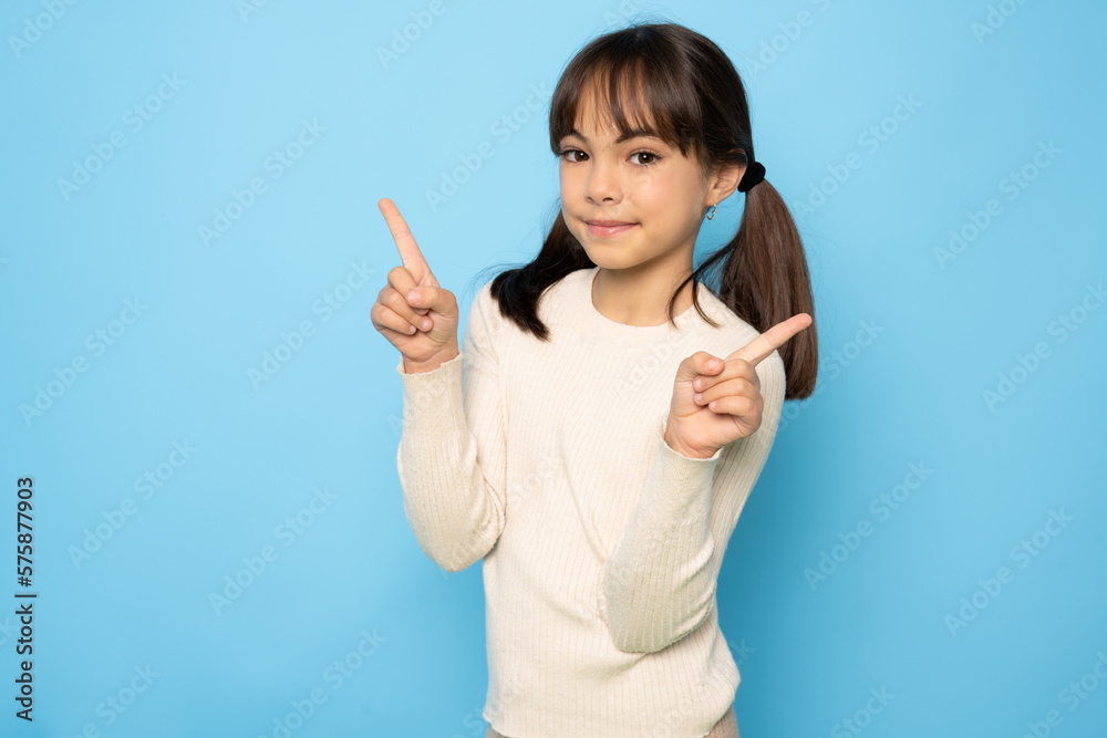 Portrait of adorable kind sweet little child girl impressed face expression promote offer isolated on blue color background Portrait of adorable kind sweet little child girl impressed face expression promote offer isolated on blue color background