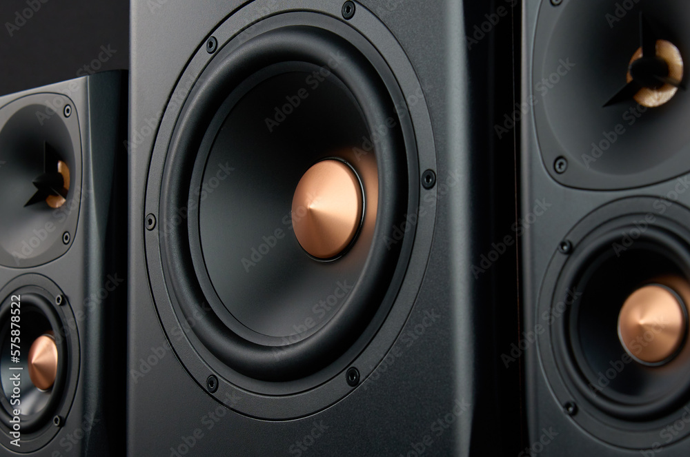Two sound speakers and subwoofer on dark background. Set for listening music. Audio equipment Two sound speakers and subwoofer on dark background. Set for listening music. Audio equipment