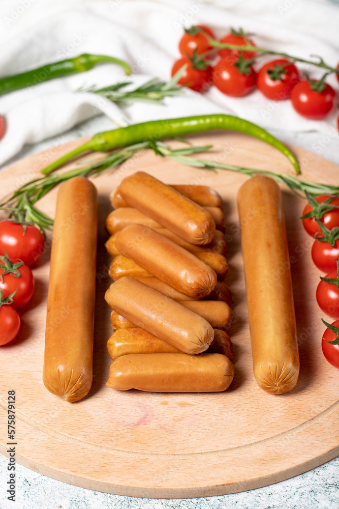 Beef sausage. Raw grilled sausages on a wood flipchart. Deli products. Beef sausage. Raw grilled sausages on a wood flipchart. Deli products.