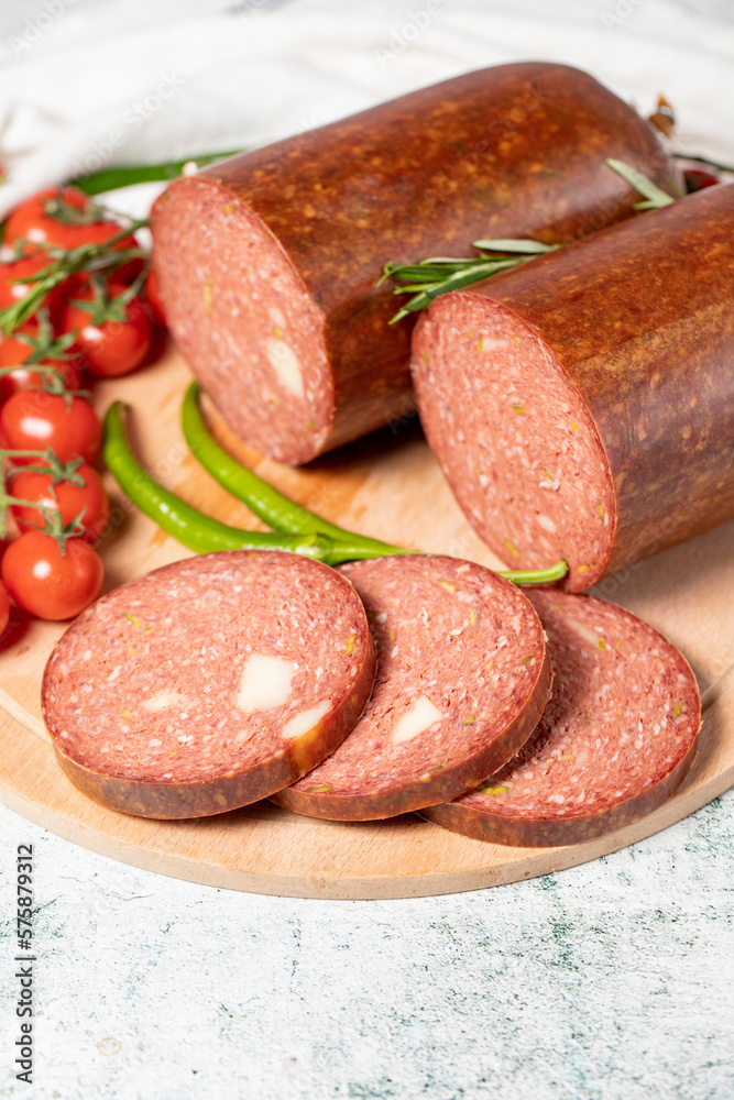 Beef sausage with cheddar. Raw grilled sausage on a wood serving board. Deli products. Close up