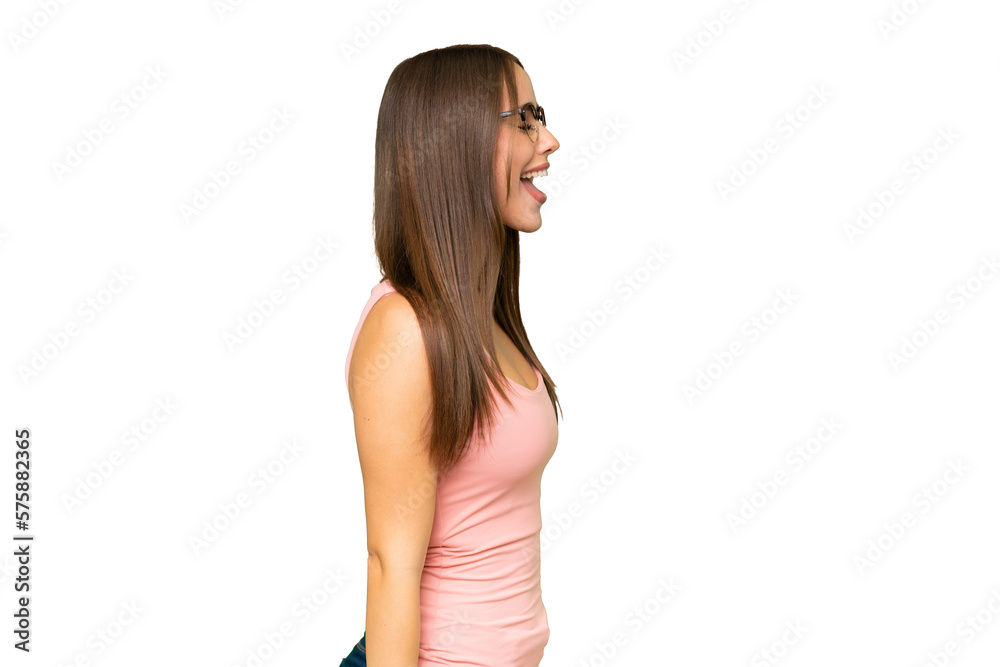 Young pretty caucasian woman over isolated background laughing in lateral position Young pretty caucasian woman over isolated background laughing in lateral position
