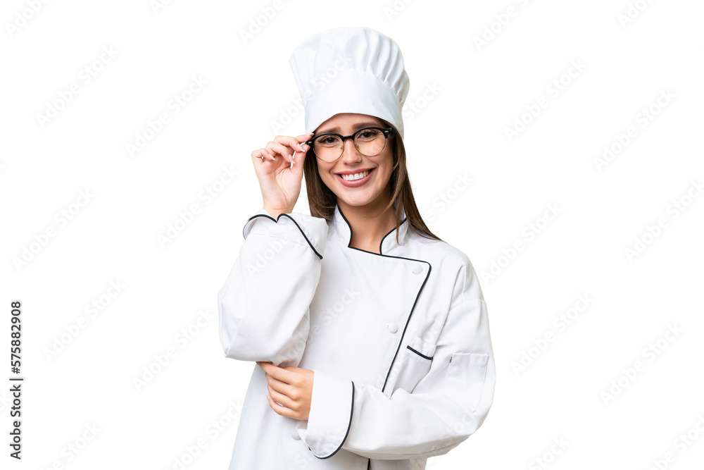 Young chef caucasian woman over isolated background with glasses and happy Young chef caucasian woman over isolated background with glasses and happy