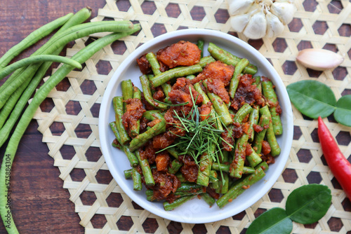Thai Red curry stir fried green beans - Asian food, In Thai called Pad Prik King at top view on wood table