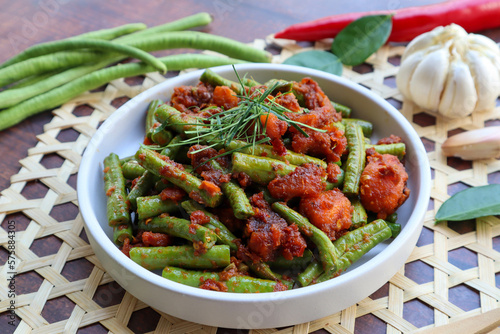 Thai Red curry stir fried green beans - Asian food, In Thai called Pad Prik King on wood table