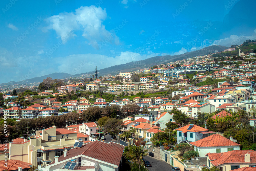 aerial view of Funchal city from cablecar - teleferico cabine on sunny winter day in february with a reflection in a window