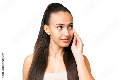 Young Arabian woman over isolated chroma key background with cotton pad for removing makeup from her face