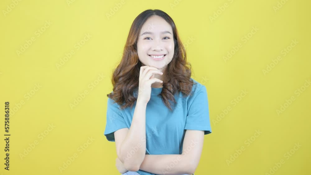 Thoughtful smiling woman having a plan idea.Isolated on yellow background. Thoughtful smiling woman having a plan idea.Isolated on yellow background.