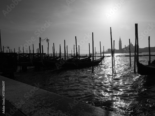 Black and white photo of gondolas moored in the grand canal in Venice.