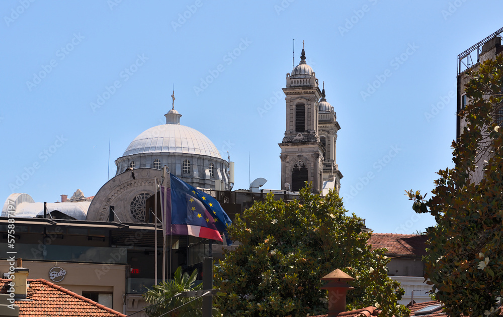 Aya Triada Rum Ortodoks Kilisesi of 1880 in the center of Istanbul in the foreground develops a European flag Aya Triada Rum Ortodoks Kilisesi of 1880 in the center of Istanbul in the foreground develops a European flag