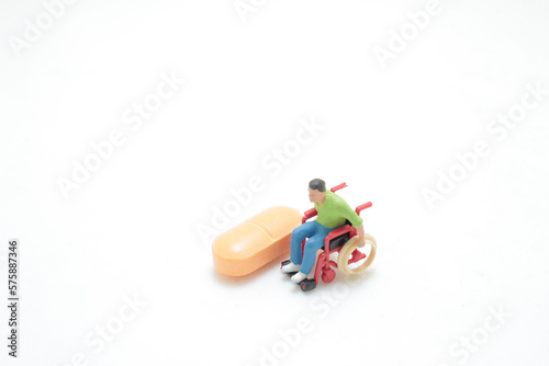 a mini figure of wheelchair with pill