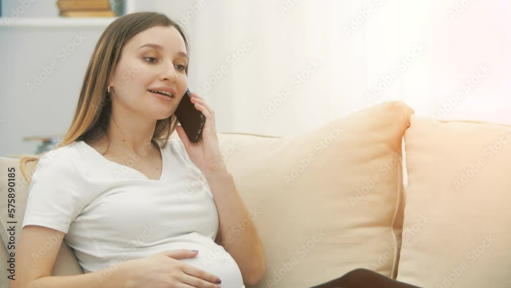 4k slowmotion video of pregnant woman talking over the phone. 4k slowmotion video of pregnant woman talking over the phone.