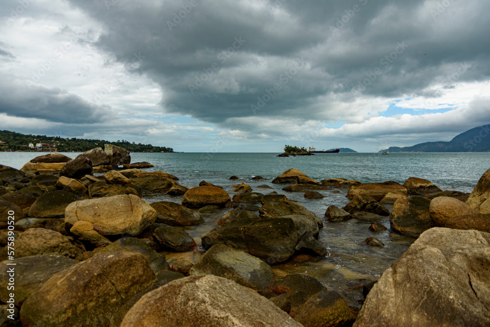 View of the rocks on the beach in a rainy day in Ilhabela, São Paulo