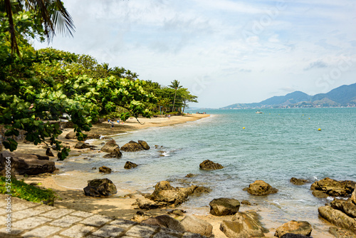 Top view of empty paradise beach surrounded by rocks and tropical forest. Ilhabela, Sao Paulo