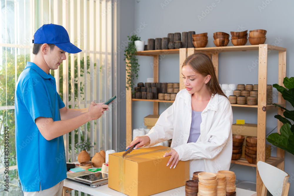 Delivery man assists the customer to record images to check the product after delivery Delivery man assists the customer to record images to check the product after delivery