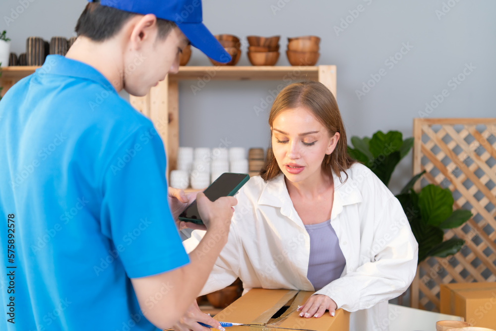 Delivery man assists the customer to record images to check the product after delivery Delivery man assists the customer to record images to check the product after delivery