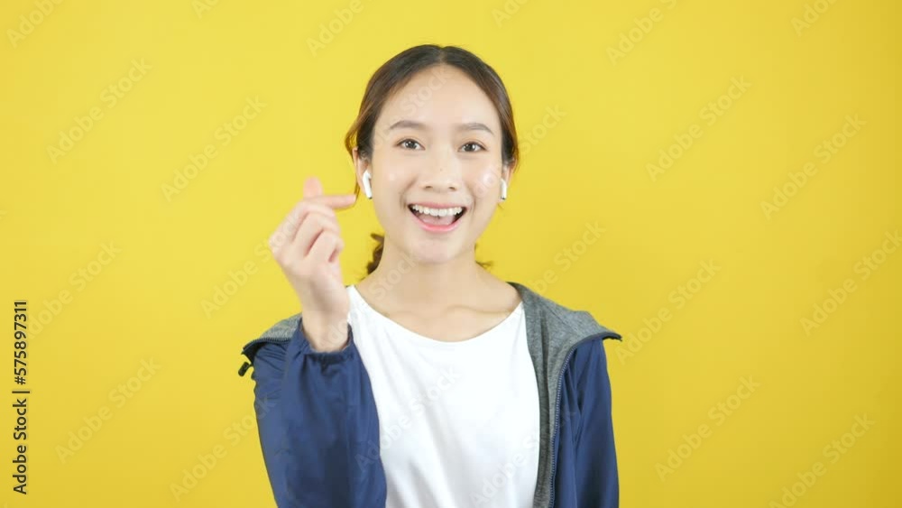 Asian Woman Wearing Headphones Smiling Brightly And Looking Through Video Camera Mini Hard Asian Woman Wearing Headphones Smiling Brightly And Looking Through Video Camera Mini Hard