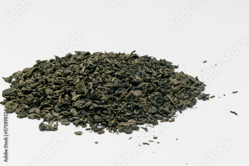Heap of dry green tea isolated on white background