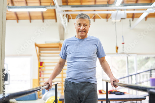 Senior man exercising on ramp at rehab center