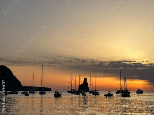 Cuadro en lienzo Sailboats Silhouetted Against a Golden Mediterranean Sunset on the Coast of Ibiz
