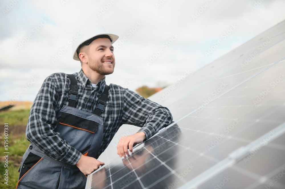 Solar power plant worker checks the condition of the panels Solar power plant worker checks the condition of the panels