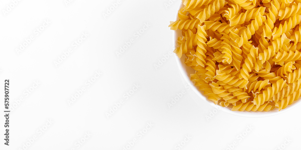 Pasta products in the form of a spiral on a plate, texture, on a white background