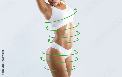 Calm young slim african american female in white lingerie enjoys weight loss result with abstract lines around body
