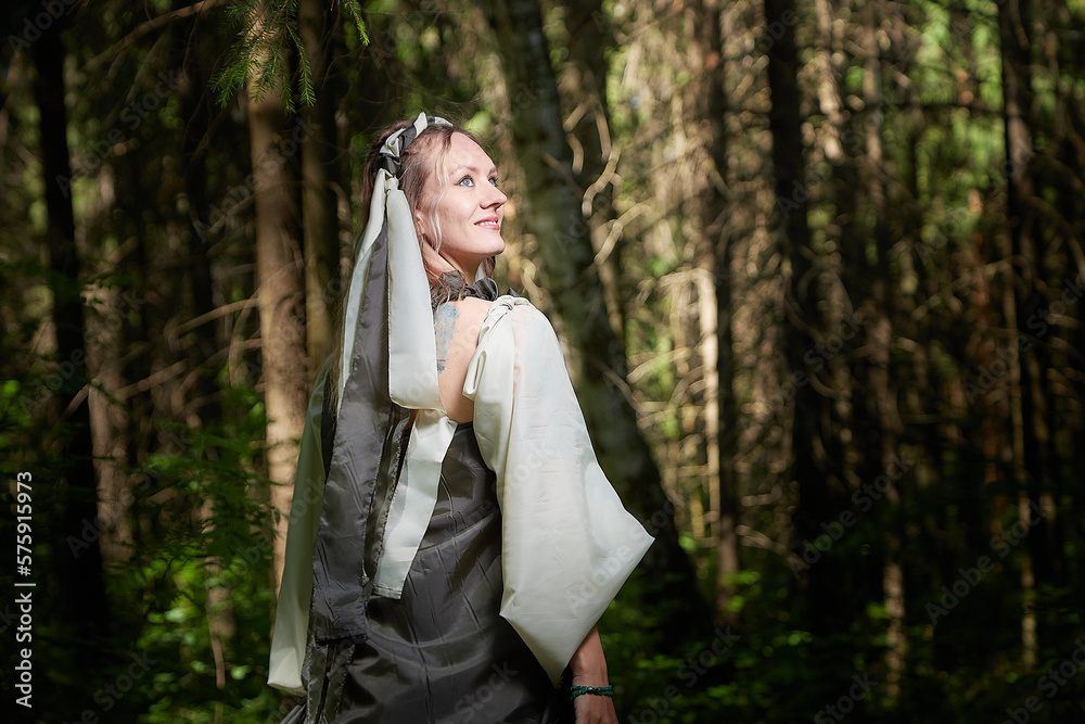 Beautiful seductive dryad. Pagan spirit of the forest. Portrait of beautiful dryad. Fairy who loves nature in beautiful green summer forest. Concept of environmental friendliness and caring for nature Beautiful seductive dryad. Pagan spirit of the forest. Portrait of beautiful dryad. Fairy who loves nature in beautiful green summer forest. Concept of environmental friendliness and caring for nature