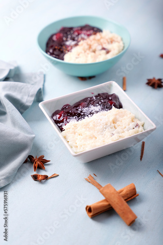 Typical Peruvian dessert: rice pudding and purple mazamorra on a light blue background. photo