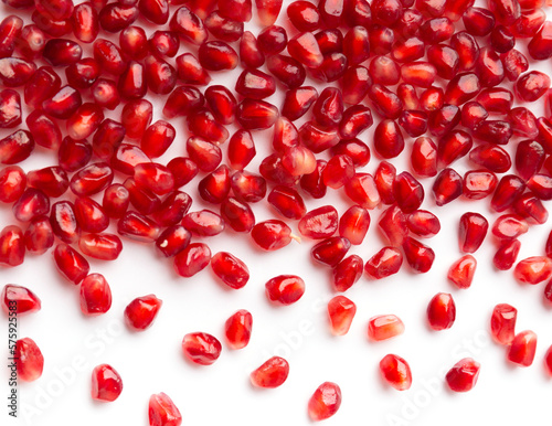 Pomegranate seeds are neatly arranged on a white background top view.