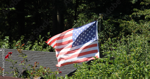 the American flag flies on the mast in the gusty wind