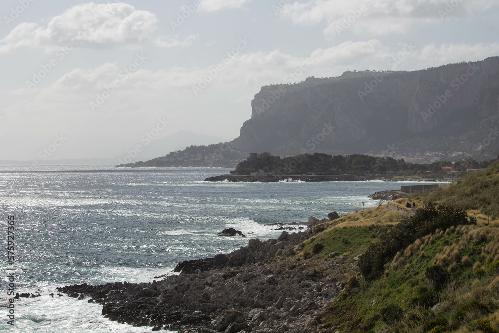 evocative image of sea coast with promontory on the background in Sicily, Italy evocative image of sea coast with promontory on the background in Sicily, Italy