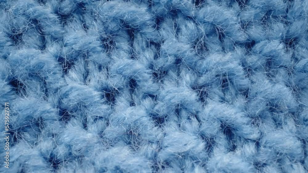 Macro dolly shot blue knit fabric texture, extreme close-up knitted clothing wool textile, detailed warm scarf or sweater, background textured surface. Shot with laowa probe lens Macro dolly shot blue knit fabric texture, extreme close-up knitted clothing wool textile, detailed warm scarf or sweater, background textured surface. Shot with laowa probe lens