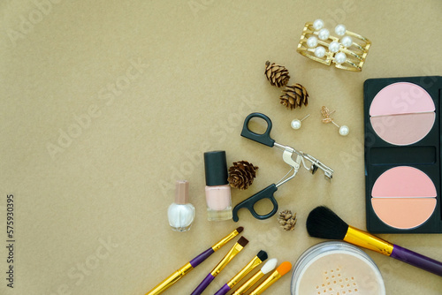 Top view of makeup products with cosmetic fashion accessories jewelry on light background. Flat lay photo. copy space for your text