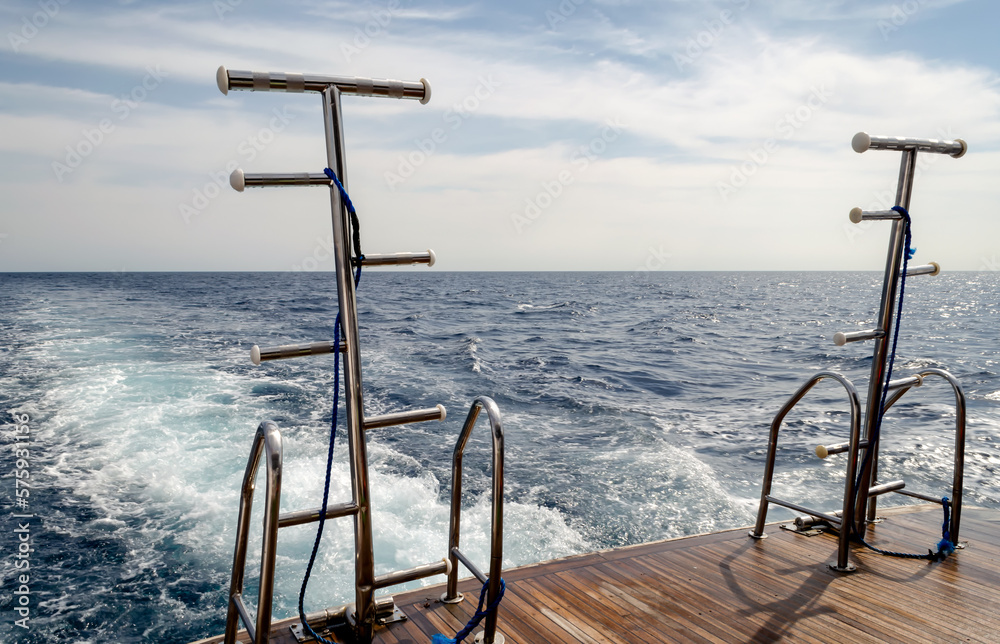 feed boats with raised ladders against the blue water of the Red Sea feed boats with raised ladders against the blue water of the Red Sea