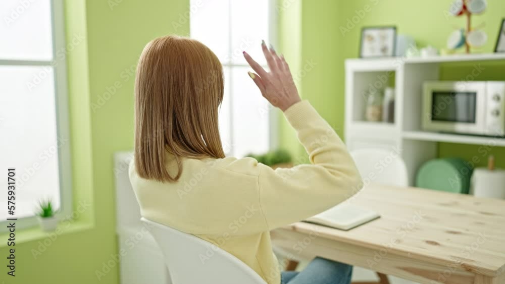 Young blonde woman reading book relaxing at home