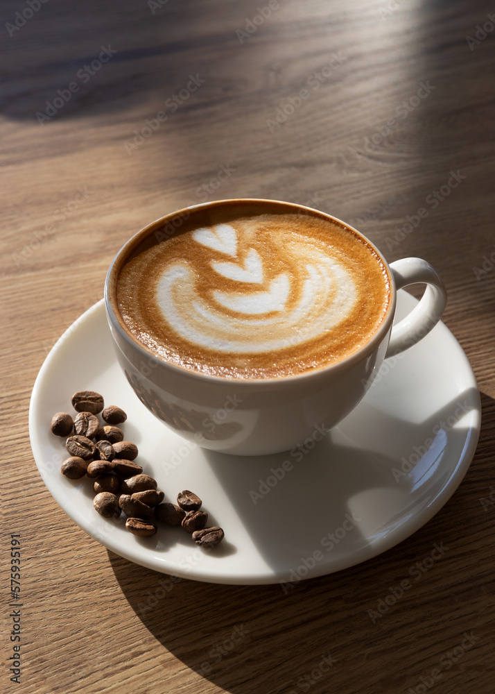Obraz premium A cup of latte with coffee beans, back light photography