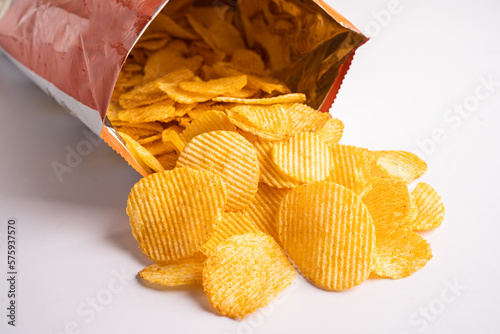Potato chips, delicious BBQ seasoning spicy for crips, thin slice deep fried snack fast food in open bag.