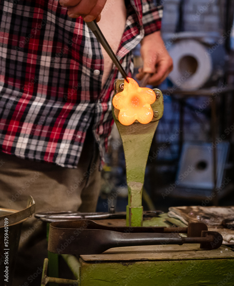 A glassworks worker shows traditional methods of making decorative glass.