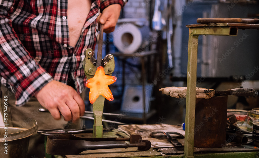 A glassworks worker shows traditional methods of making decorative glass.