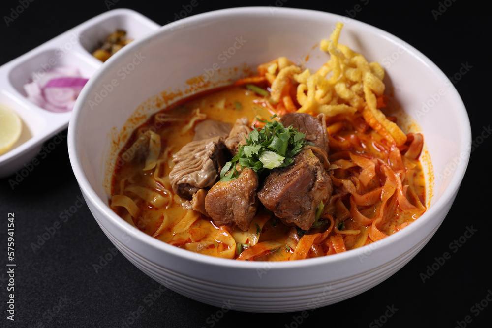 Khao Soi Thai Curry soup isolated in black background Khao Soi Thai Curry soup isolated in black background
