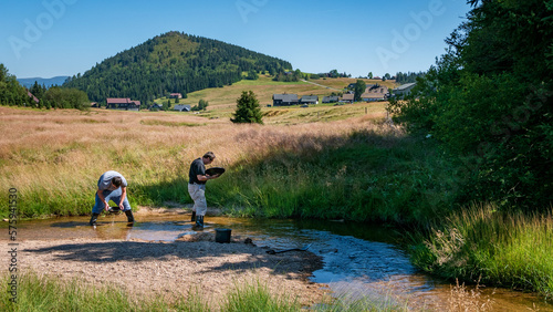 Men are gold panning in mountain streams. photo