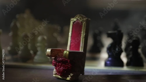 Red royal chair (Medieval Throne) miniature on chessboard. . Chess board game concept of business ideas and competition and strategy ideas concept. Selective focus