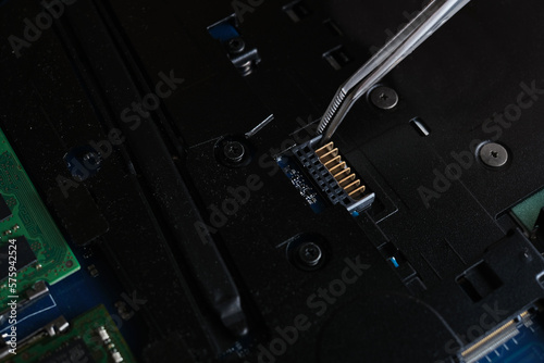 master repairing laptop and system board close-up