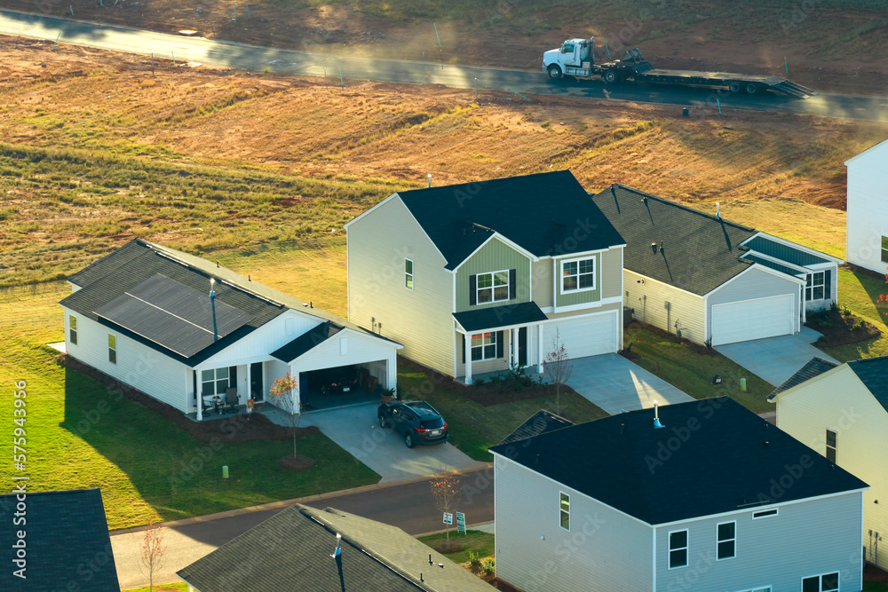 View from above of densely built residential houses in living area in South Carolina. American dream homes as example of real estate development in US suburbs View from above of densely built residential houses in living area in South Carolina. American dream homes as example of real estate development in US suburbs