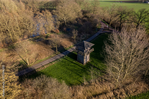 Top down aerial view of preserved wooden Roman watch tower on archaeological site castellum Fectio in Dutch landscape with barren trees surrounding the historic observatory and defensive structure photo